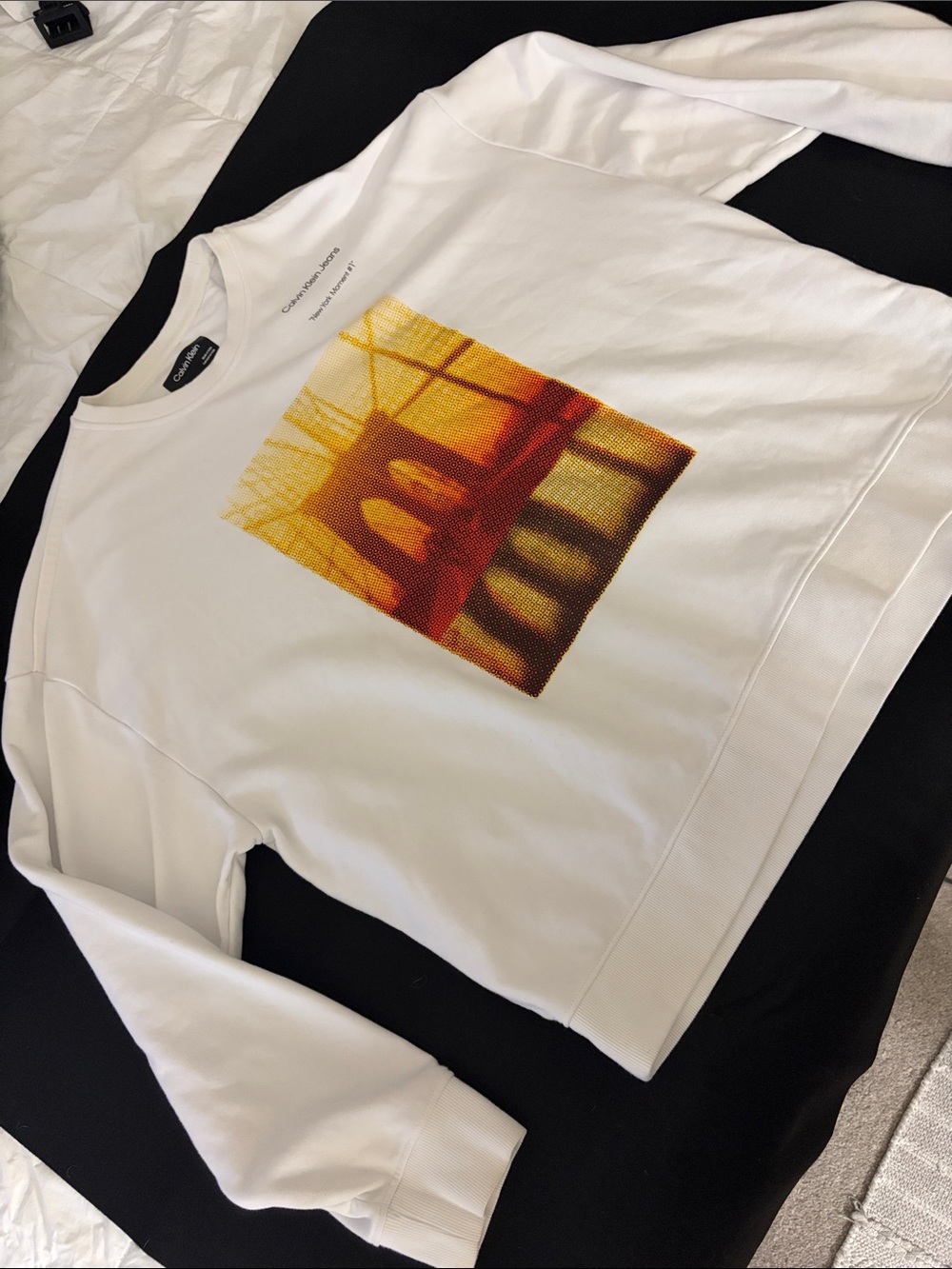 Calvin Klein Jeans White Crewneck Sweatshirt with Yellow-Orange Bridge Graphic